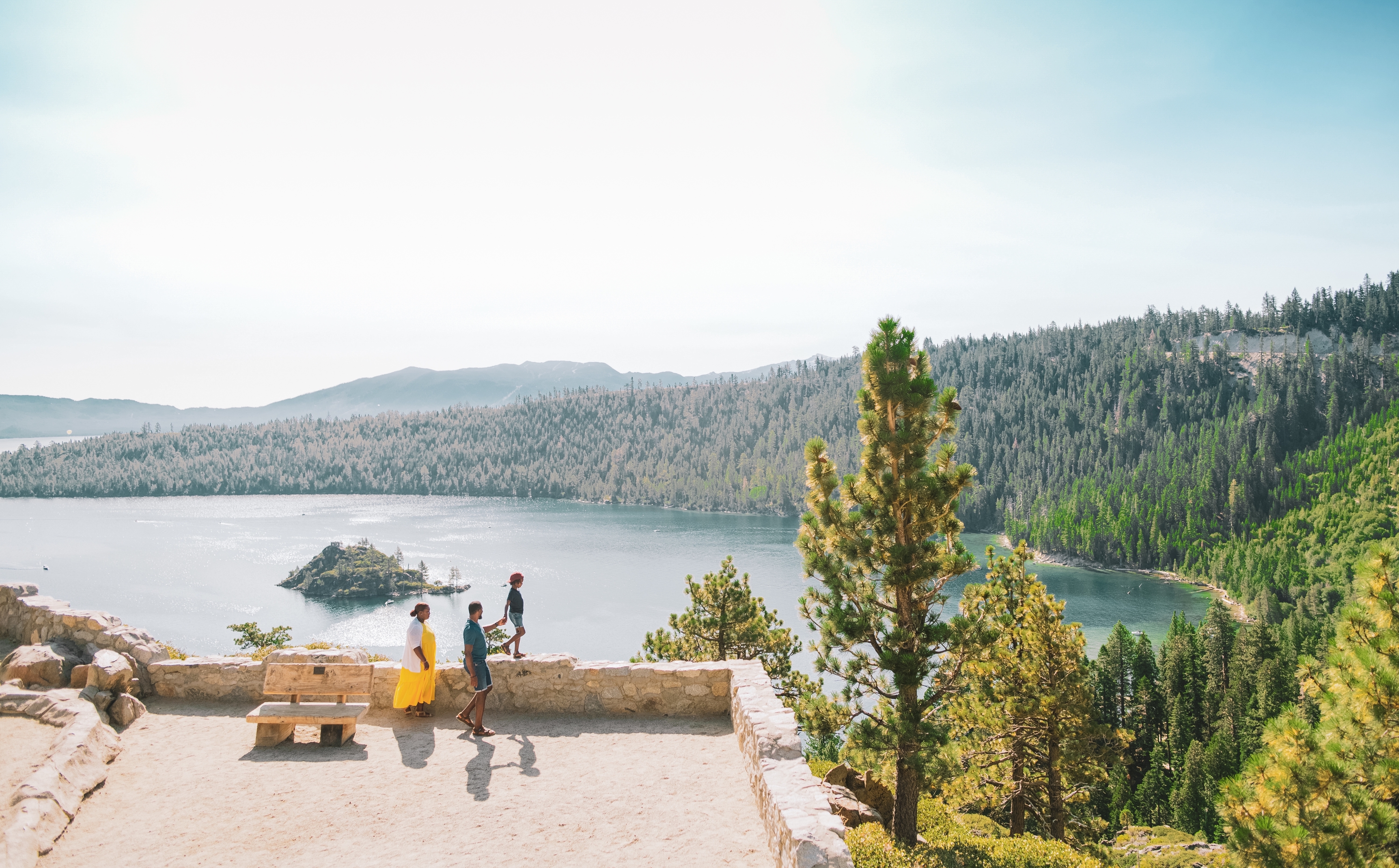 Karen and her family at Emerald Bay State Park with the gorgeous forest, mountains and lake as a backdrop.