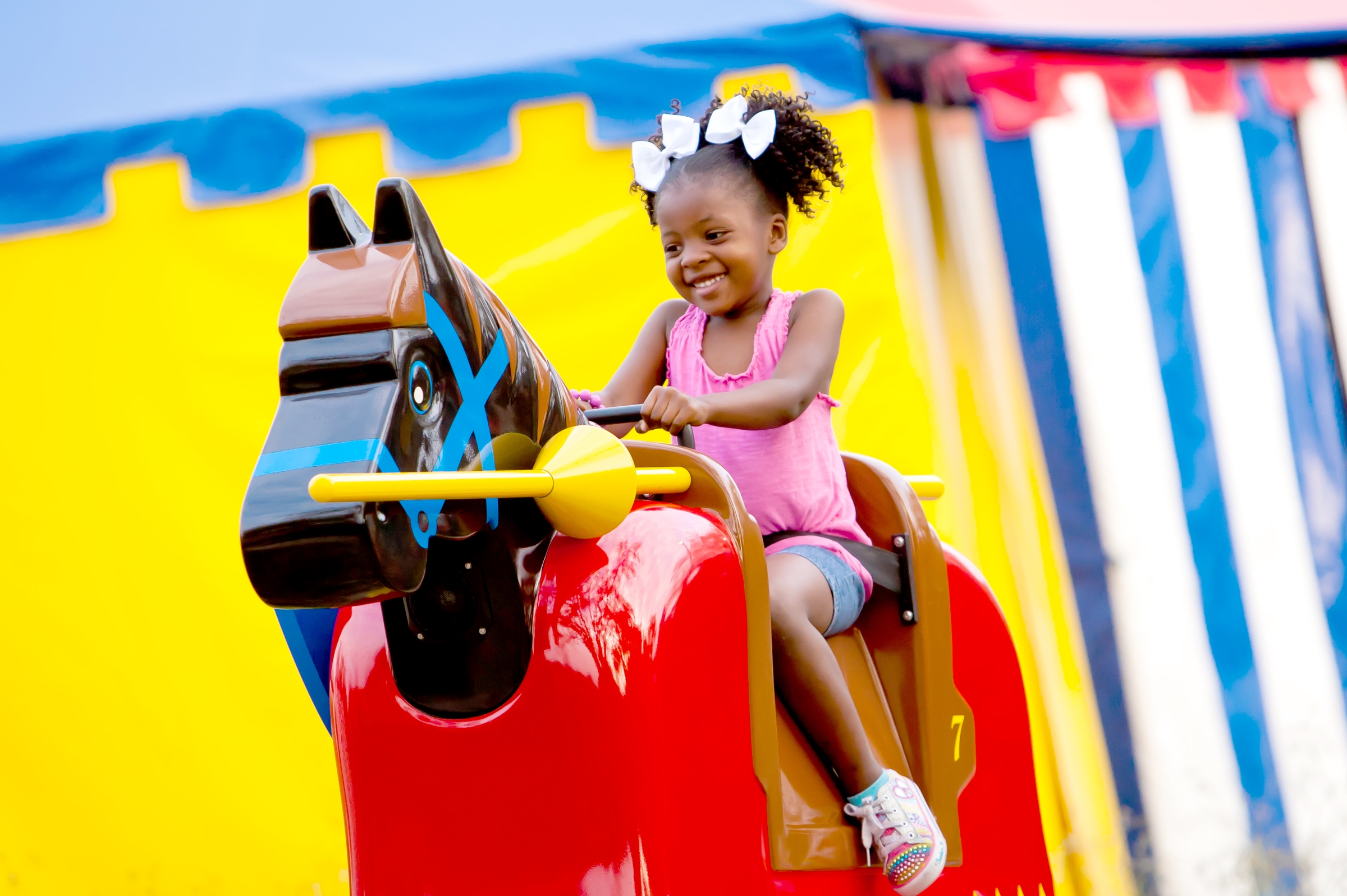 Small child riding mechanical horse at LEGOLAND Florida