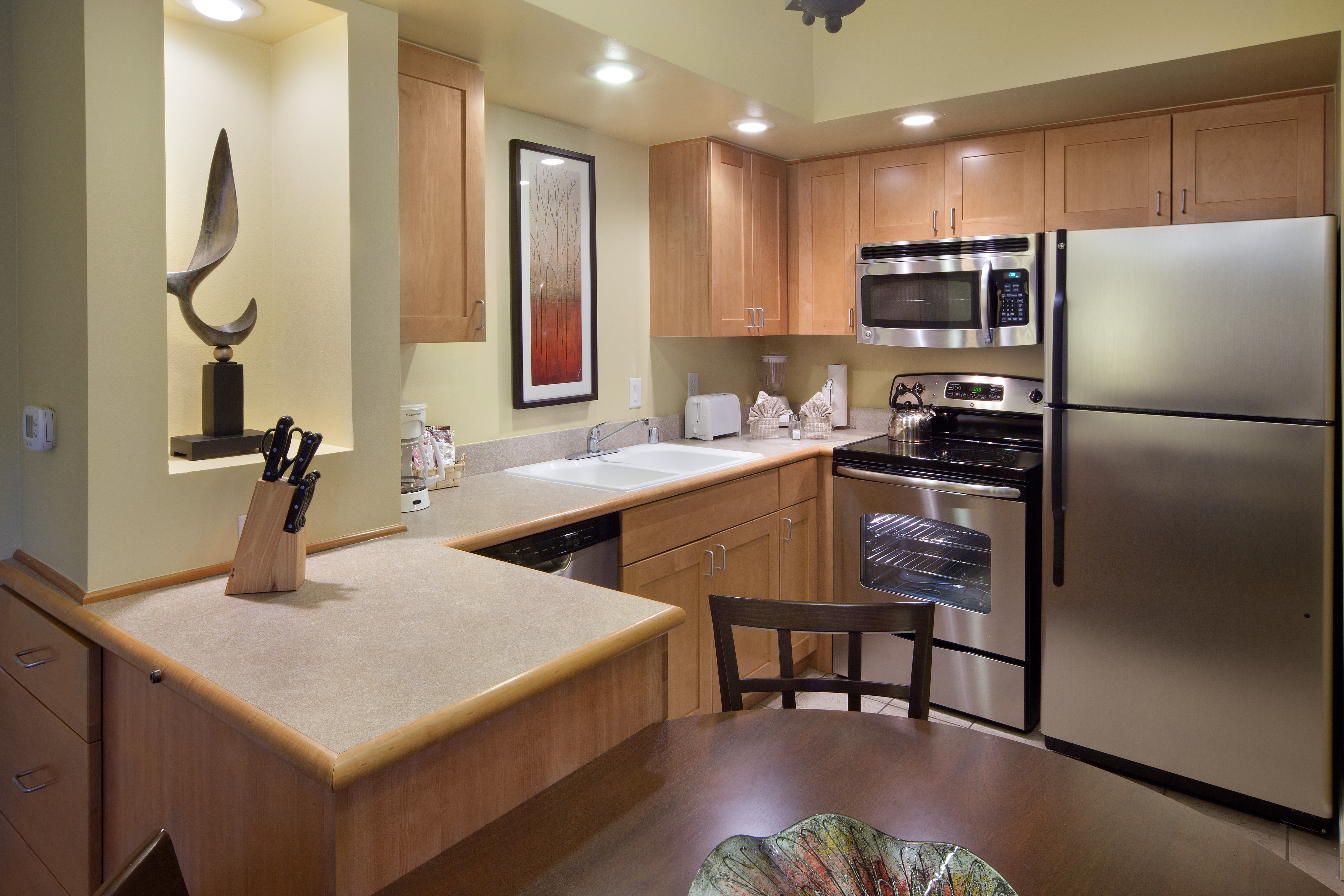 Kitchen with stainless steel fridge, microwave, sink, oven, and dishwasher in a villa at Lake Geneva Resort