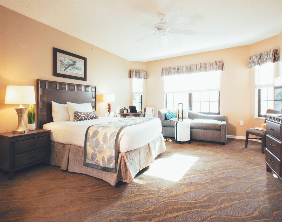 Bedroom with seating area in a three bedroom villa in West Village at Orange Lake Resort near Orlando, FL