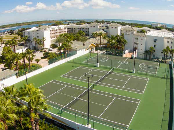 Aerial view of two tennis courts and a basketball court at Cape Canaveral Beach Resort.