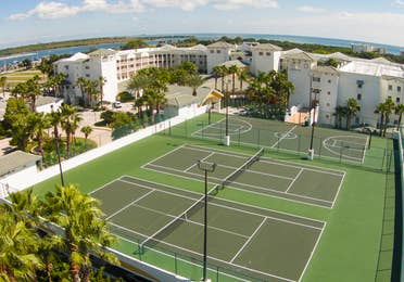 Aerial view of two tennis courts and a basketball court at Cape Canaveral Beach Resort.