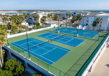 Aerial view of two tennis courts and a basketball court at Cape Canaveral Beach Resort.