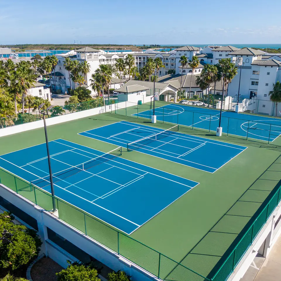 Aerial view of two tennis courts and a basketball court at Cape Canaveral Beach Resort.