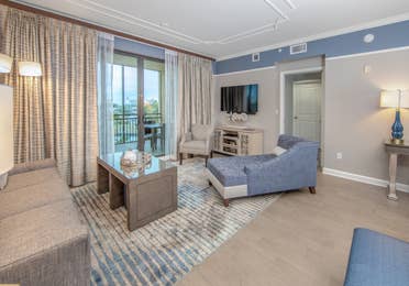 Living room with coastal decor and flat screen TV in a three-bedroom villa at Sunset Cove Resort in Marco Island, Florida