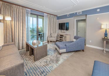 Living room with coastal decor and flat screen TV in a three-bedroom villa at Sunset Cove Resort in Marco Island, Florida