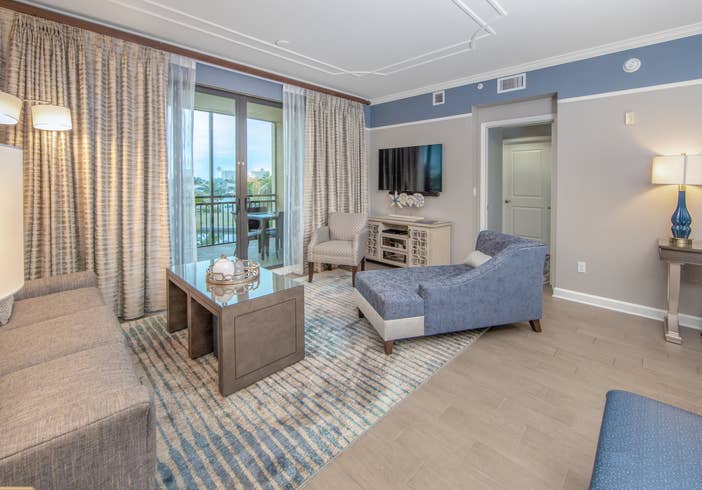 Living room with coastal decor and flat screen TV in a three-bedroom villa at Sunset Cove Resort in Marco Island, Florida