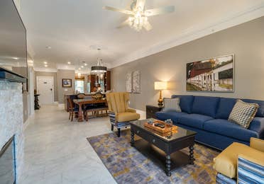 Living room and dining area in a Signature Collection villa at Williamsburg Resort.