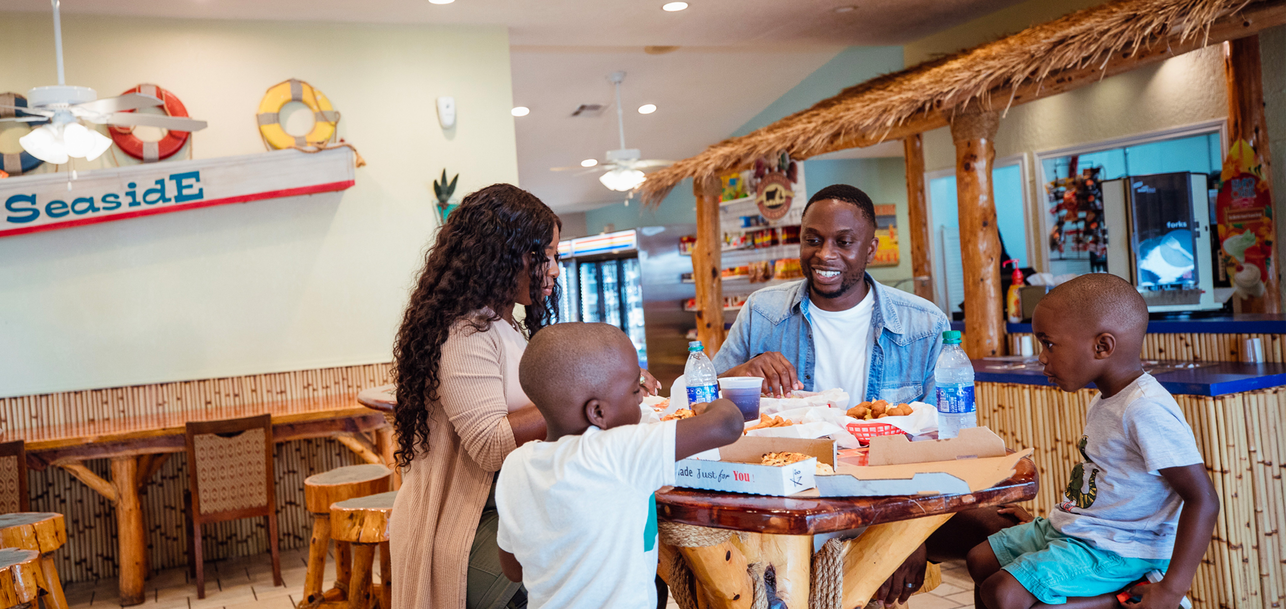 Family enjoying food at the Seaside Grill, Galveston Seaside Resort