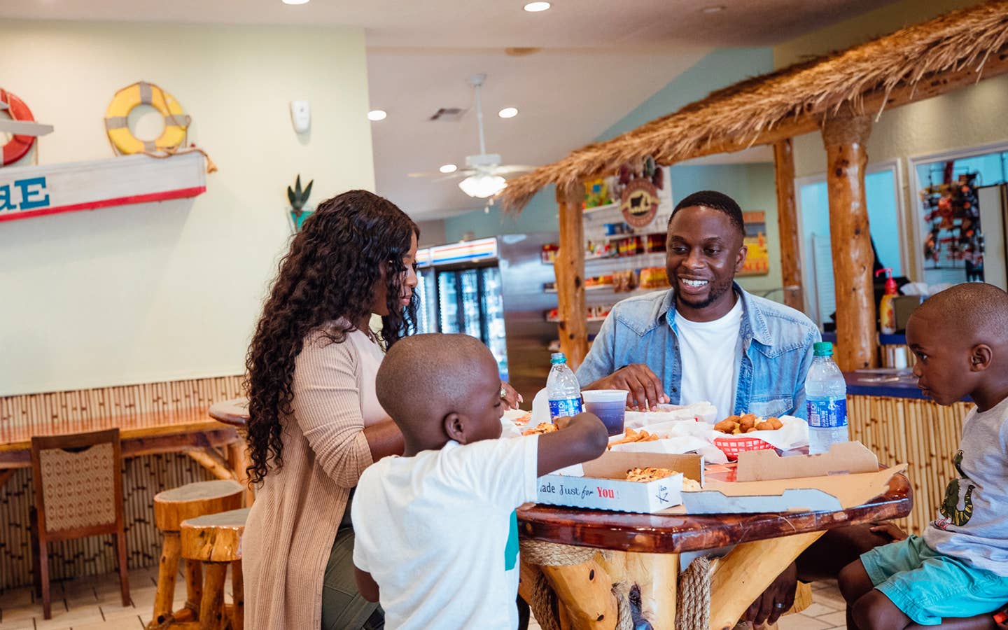 Family enjoying food at the Seaside Grill, Galveston Seaside Resort