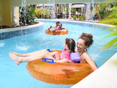 family swimming in pool