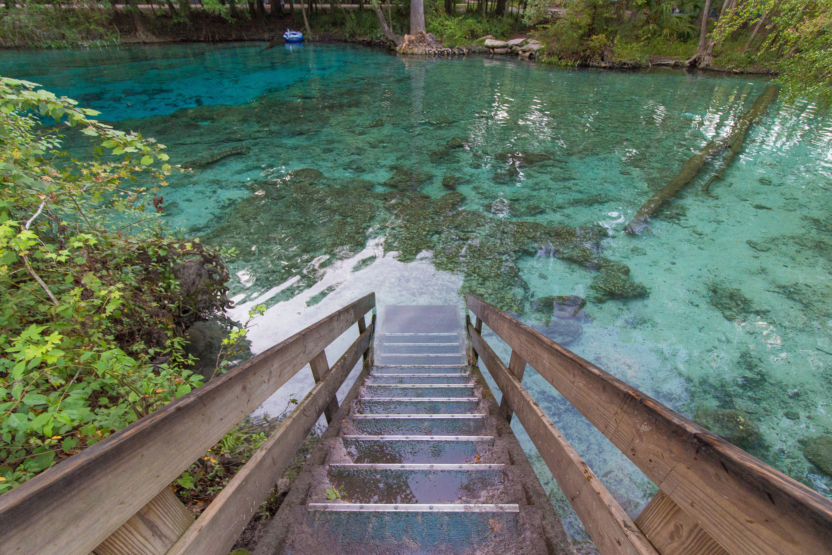 Stairs descending into crystal blue waters at Blue Spring State Park