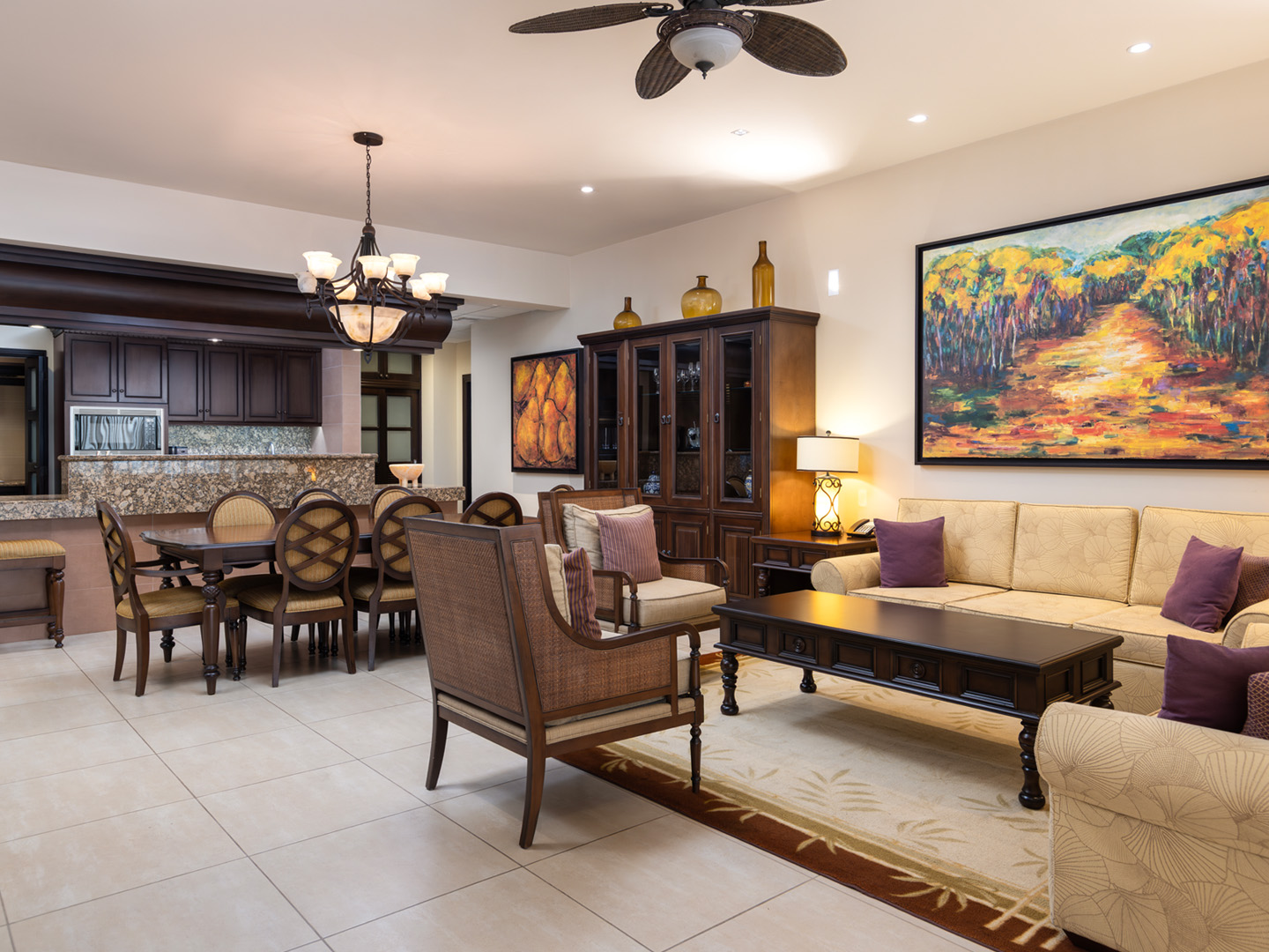 Spacious suite living area with dining table, kitchen, and seating.