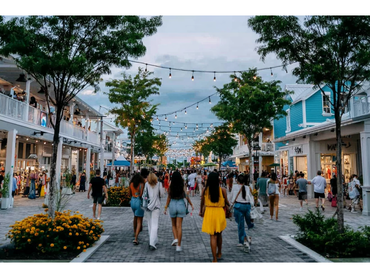 Shoppers walking through a lively outdoor shopping district.