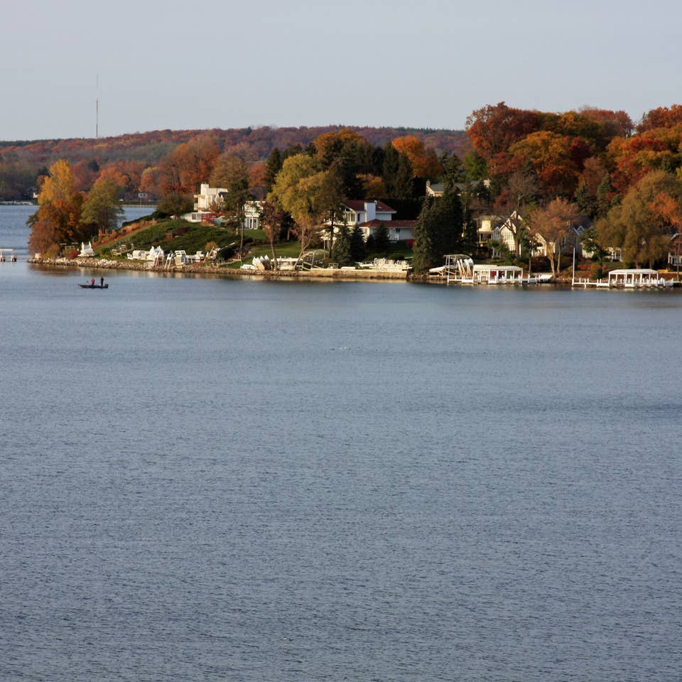 View of trees on edge of lake in Lake Geneva, Wisconsin.