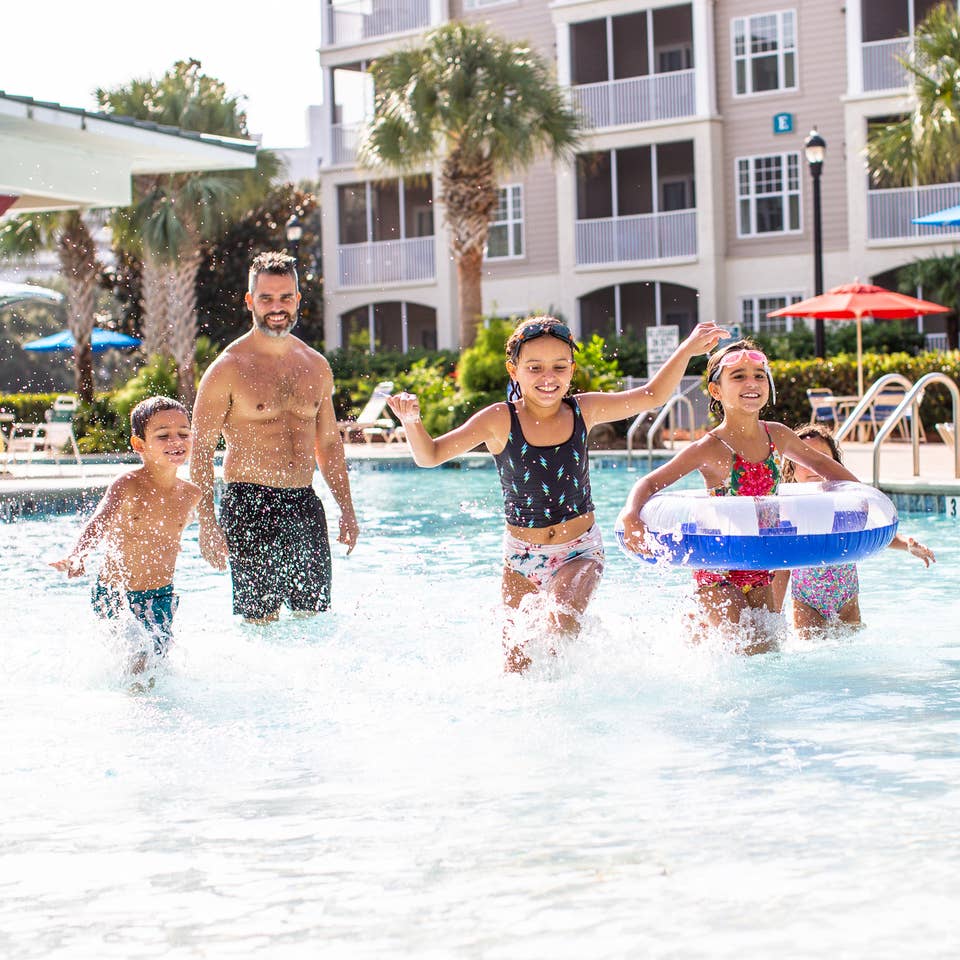 Family of four playing in pool at South Beach Resort in Myrtle Beach, South Carolina.
