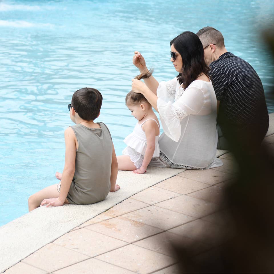 Family sitting near the pool at Orange Lake Resort in Orlando, FL