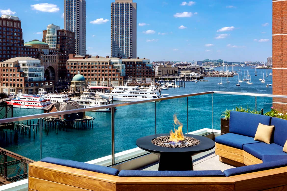 A rooftop bar overlooks the Boston Harbor.