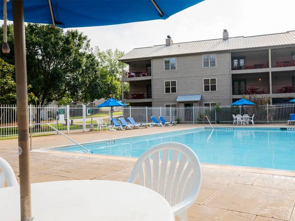 Outdoor lodge pool with view of property building at Villages Resort in Flint, Texas