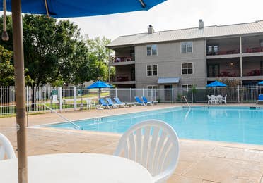 Outdoor lodge pool with view of property building at Villages Resort in Flint, Texas