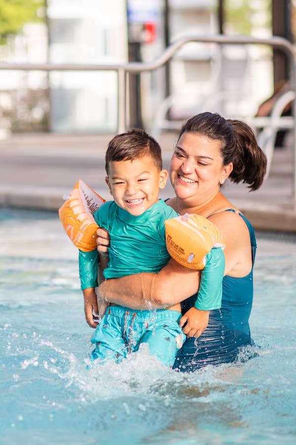 Mother holding child in indoor pool at Holiday Hills Resort in Branson, Missouri.