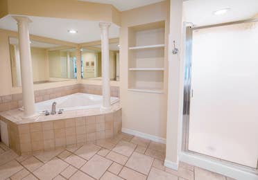Bathroom with tub and walk-in shower in a two-bedroom presidential villa at Fox River Resort in Sheridan, Illinois.