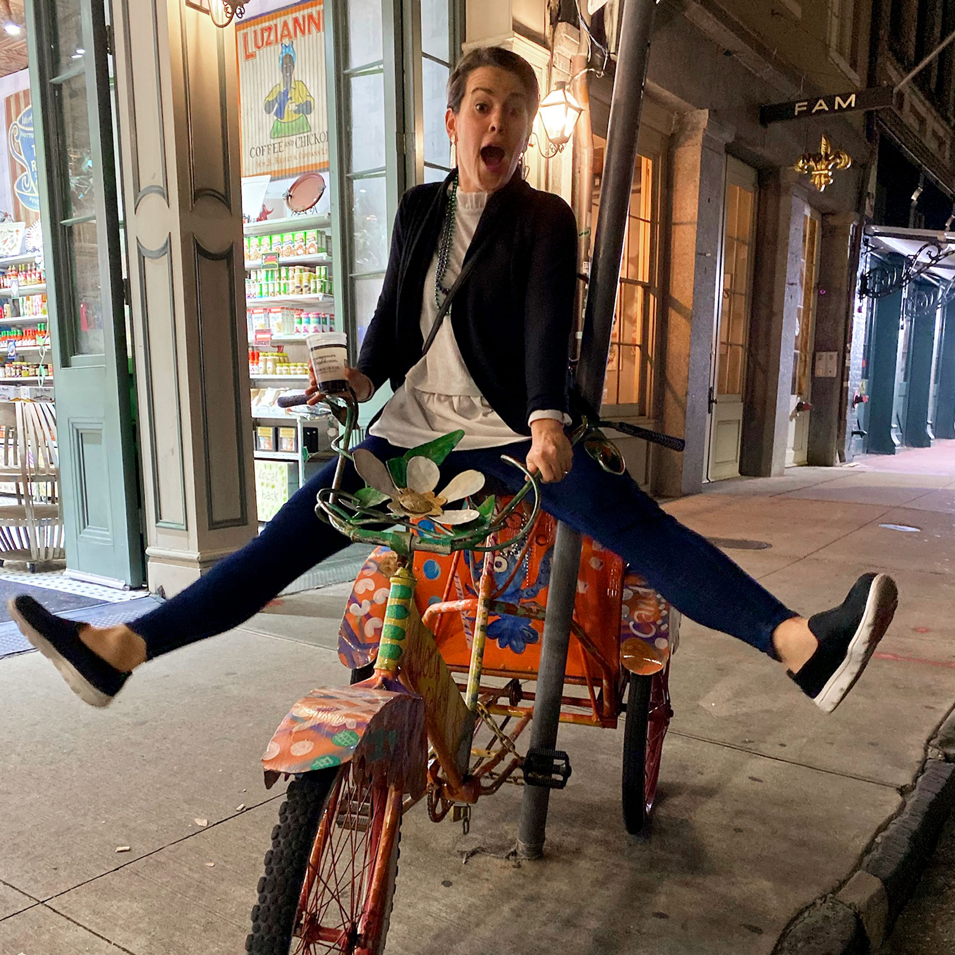 Author, Jenn Harmon, rides a stationary bike decorated on Bourbon Street.