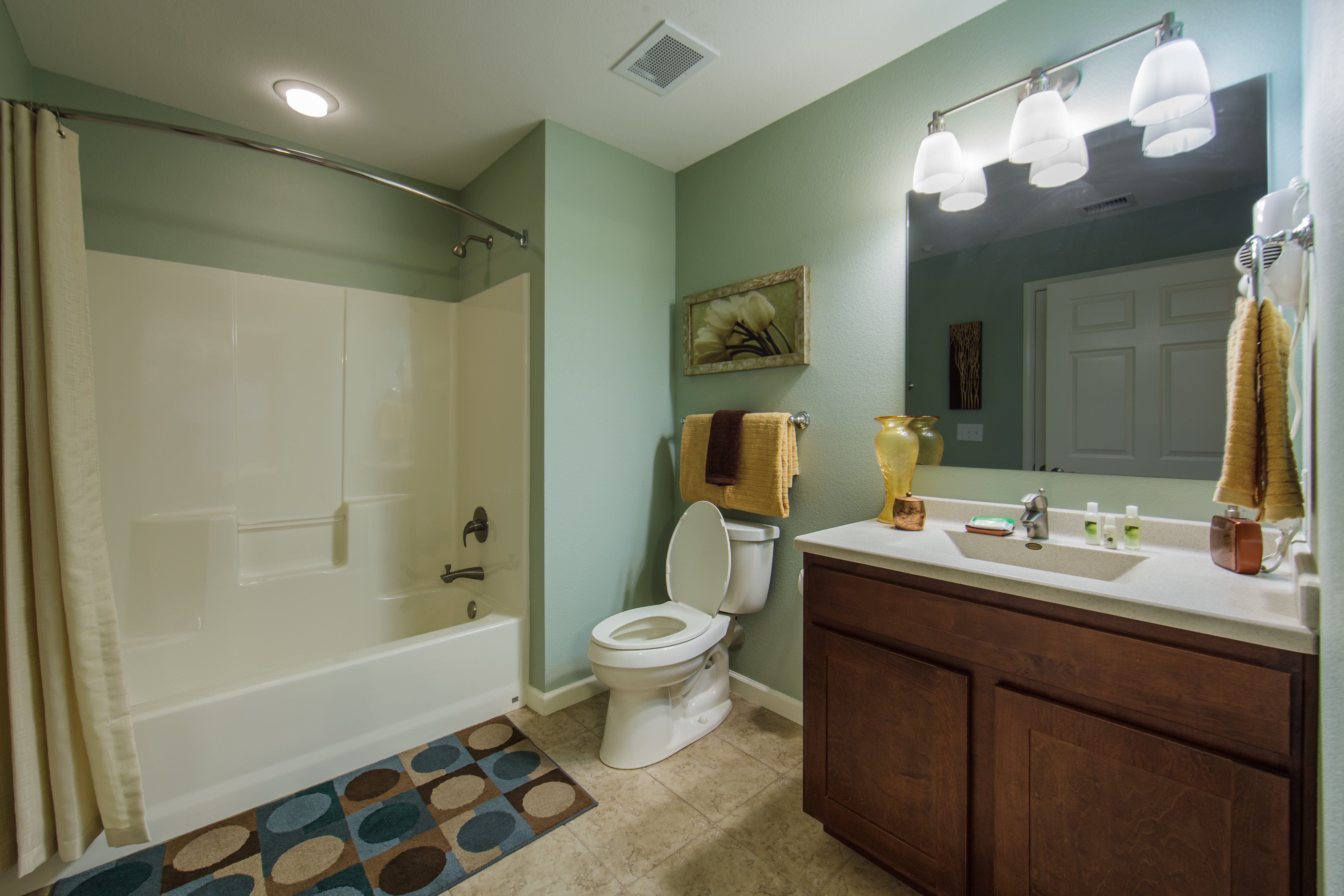 Bathroom with vanity and bathtub in a three-bedroom ambassador villa at the Holiday Hills Resort in Branson Missouri.