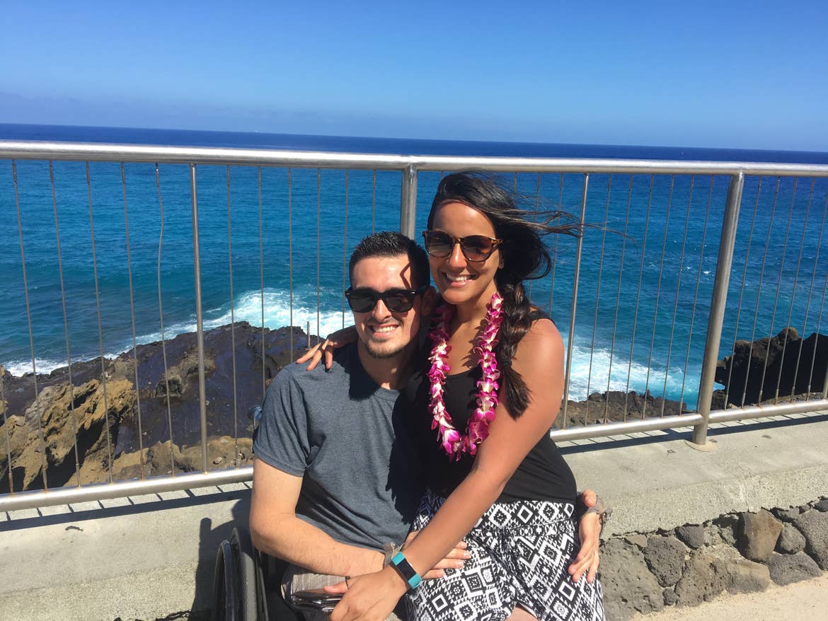 Danny and his wife at an overlook in front of the ocean in Hawaii.