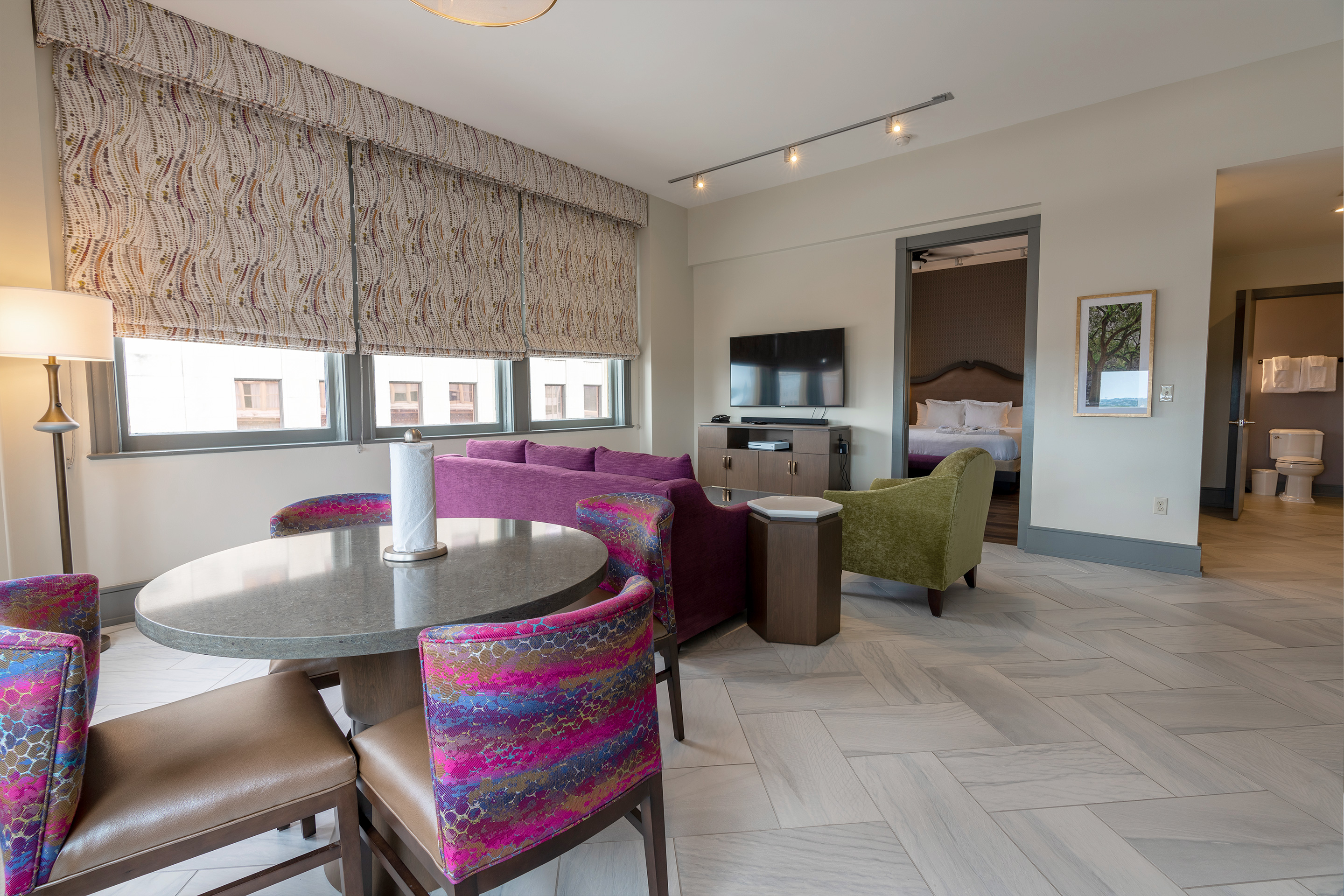 Signature Collection one-bedroom villa living area with couch, chair, dining area and full kitchen at New Orleans Resort in Louisiana.