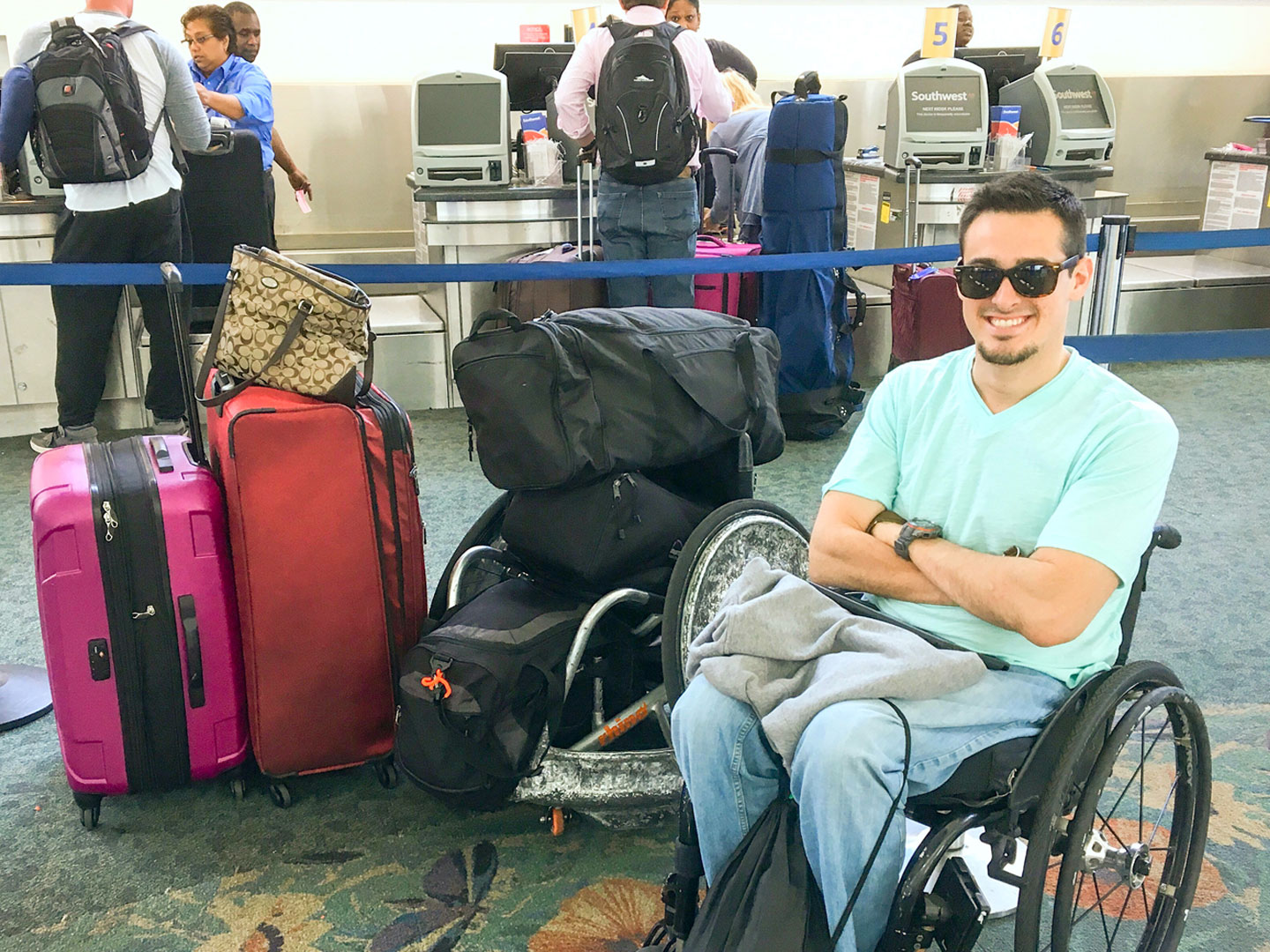 Danny at the airport next to all his luggage