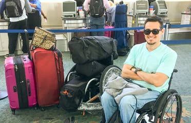 Danny at the airport next to all his luggage