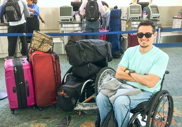 Danny at the airport next to all his luggage