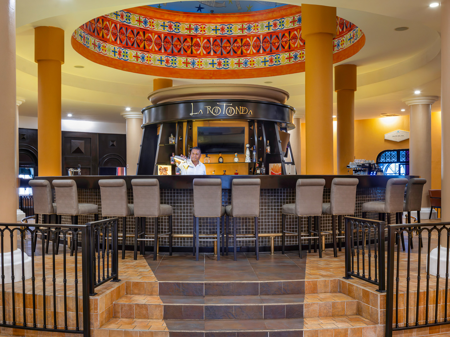 An inviting central bar framed by warm colors and light.