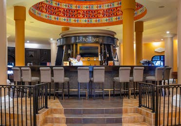 An inviting central bar framed by warm colors and light.