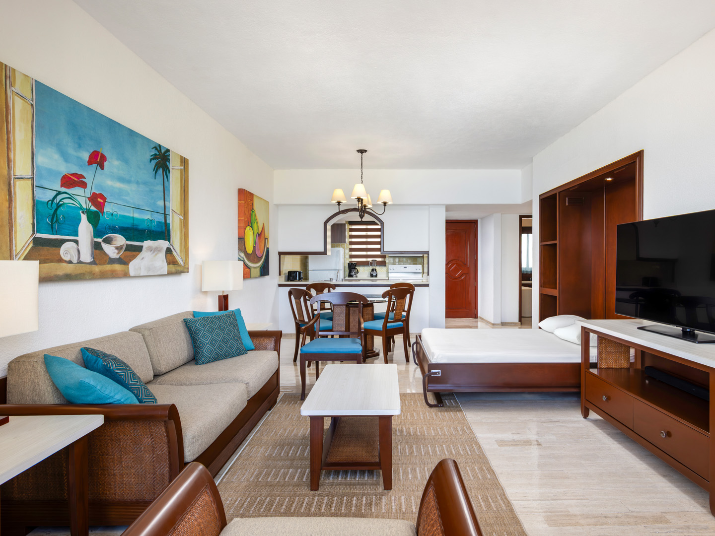 Villa living room with sofa, dining area, and TV. 