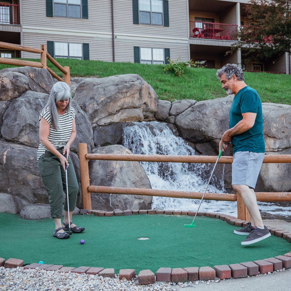 A couple playing mini golf at Oak n' Spruce Resort in South Lee, Massachusetts.