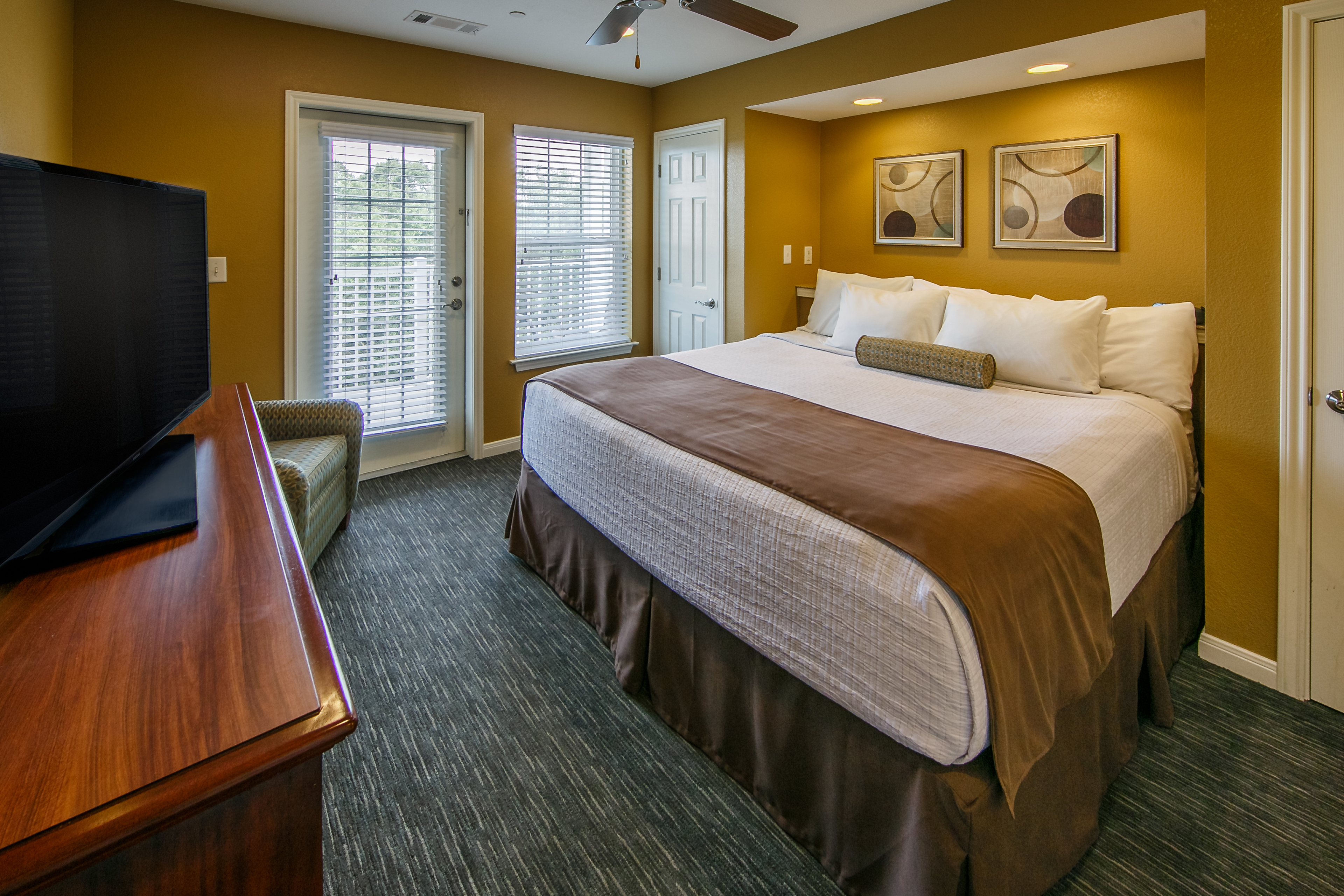 Master bedroom with TV in a two-bedroom ambassador villa at the Hill Country Resort in Canyon Lake, Texas.