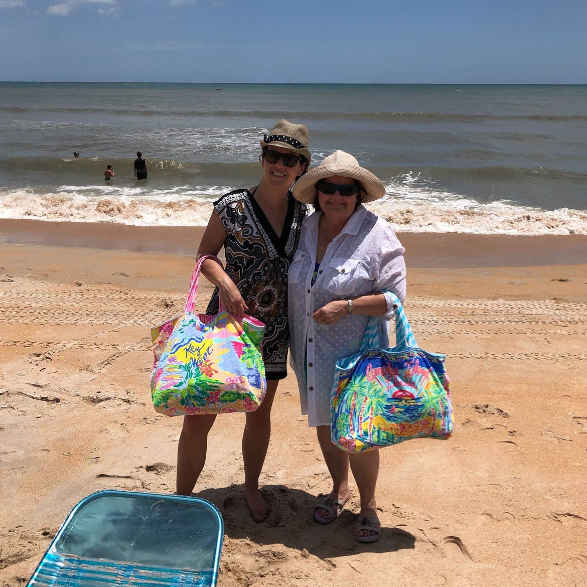 Featured Contributor, Jenn C. Harmon (left) and her mom (right) pose on the sands of Flagler Beach in Florida while holding their matching Vera Bradley beach bags.
