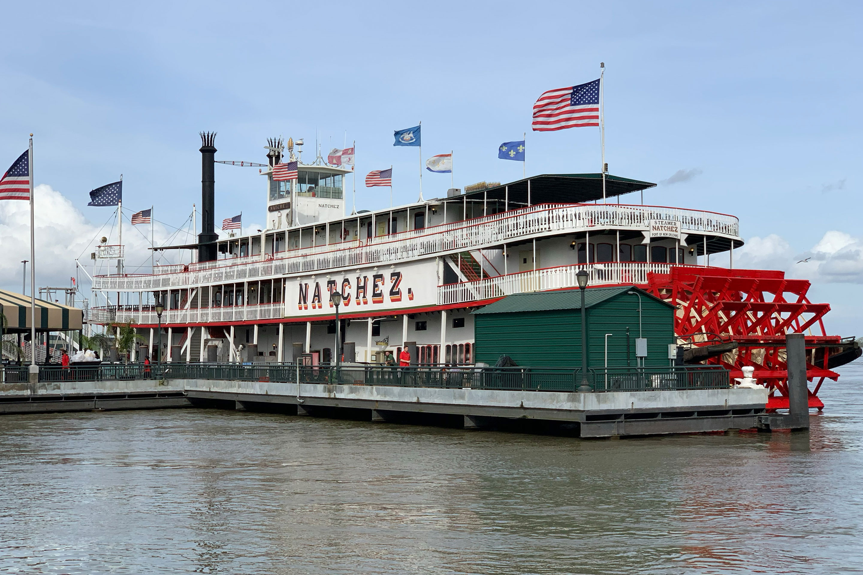 The City of New Orleans Natchez Steamboat docked on the Mississippi River.