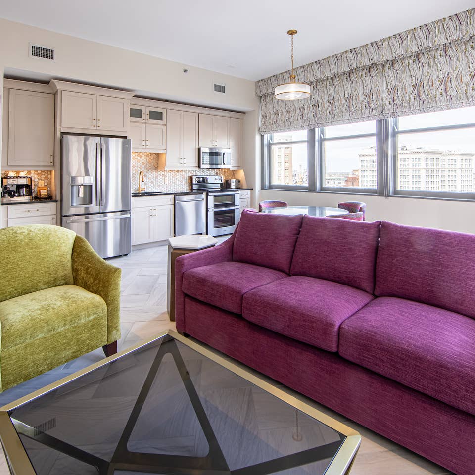Living room and kitchen in a one-bedroom Signature Collection villa at New Orleans Resort in Louisiana.