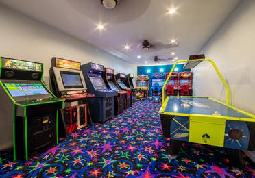 Game room with arcade games and air hockey at Fox River Resort in Sheridan, Illinois.