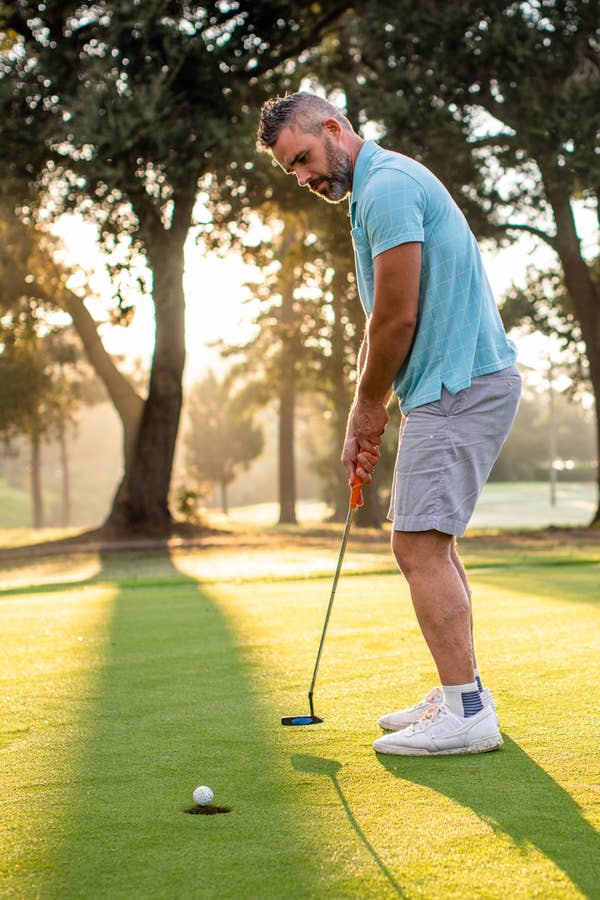 Man putting on golf course at near South Beach Resort in Myrtle Beach, South Carolina.