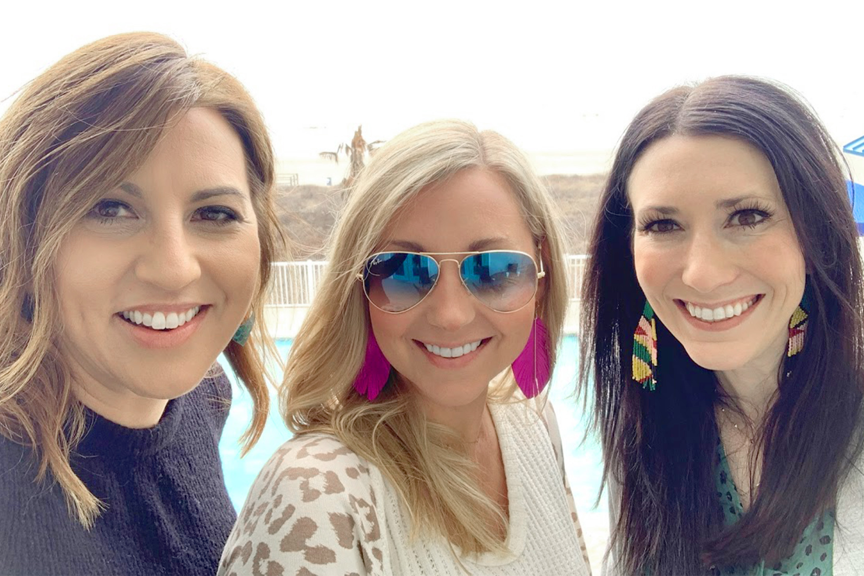 Featured Contributor, Amanda Nall (middle) poses with her two friends on the beach near our Galveston Beach Resort in Galveston, Tx.