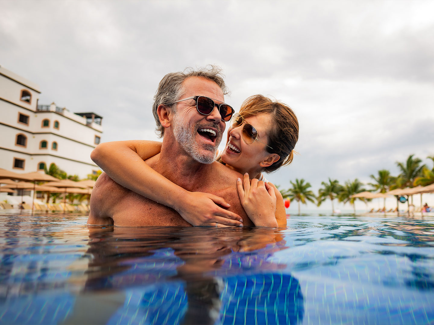 Couple in the pool at the Grand Residences Resort in Puerto Morelos, Mexico