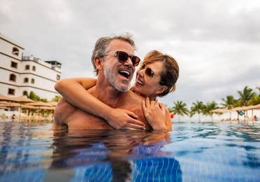 Couple in the pool at the Grand Residences Resort in Puerto Morelos, Mexico