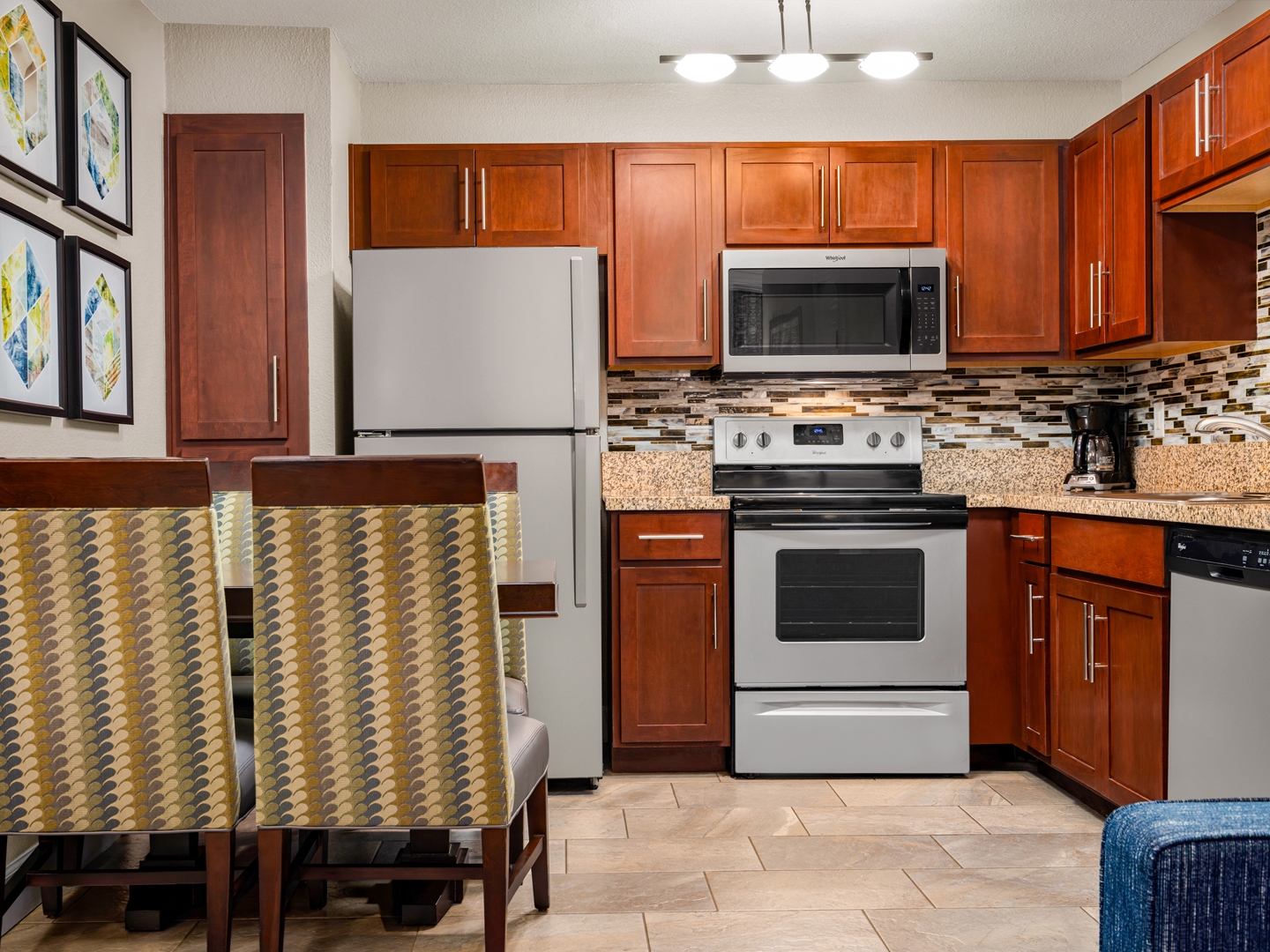 Modern kitchen with stainless steel appliances and dining area.
