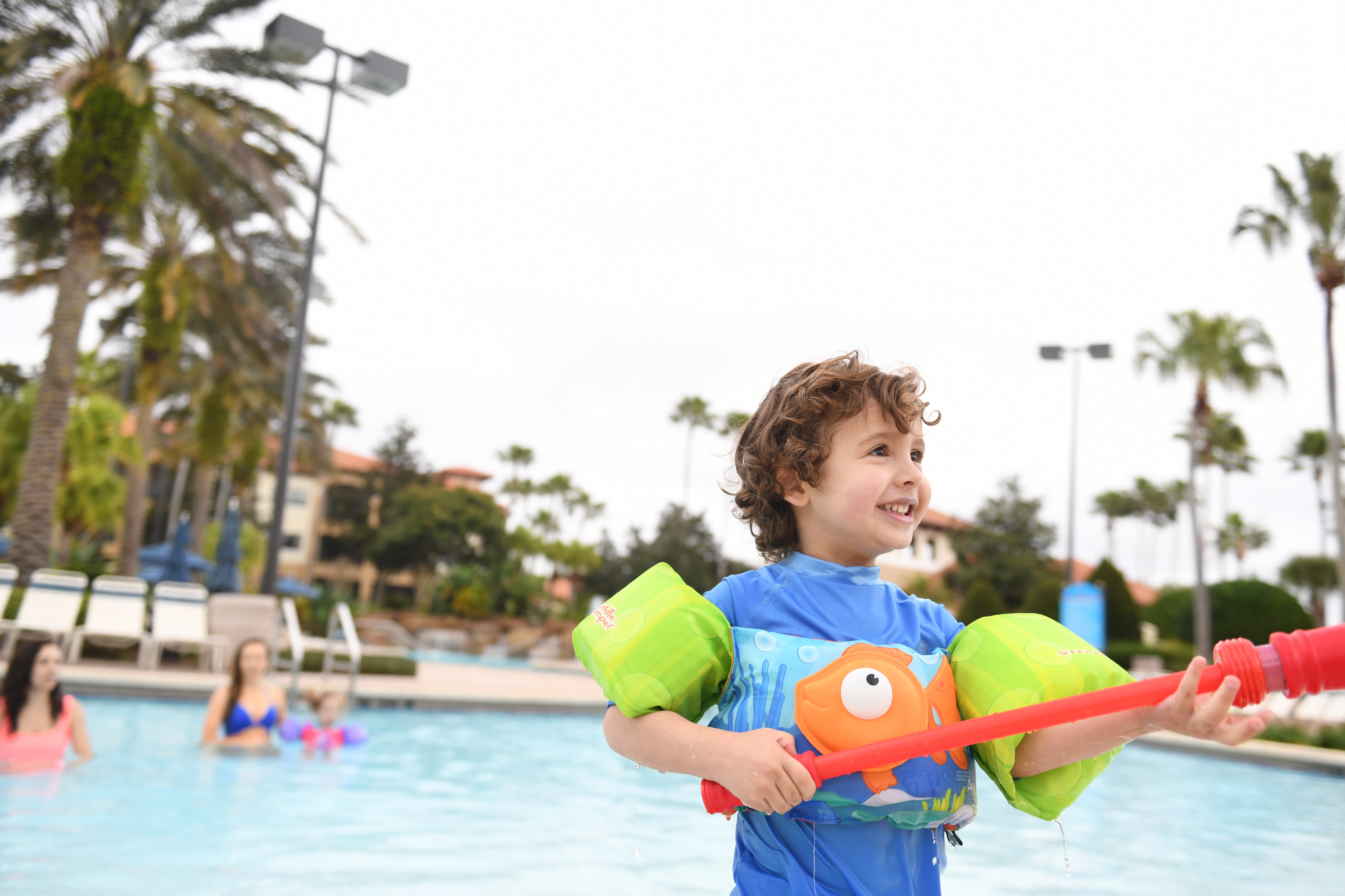 Young child standing by pool at Orange Lake Resort near Orlando, Florida