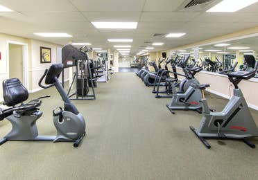 Fitness center with several machines including weights and stationary bikes at Oak n' Spruce Resort in South Lee, Massachusetts.