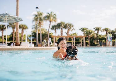 Mother and child swimming in pool at Cape Canaveral Beach Resort in Florida.